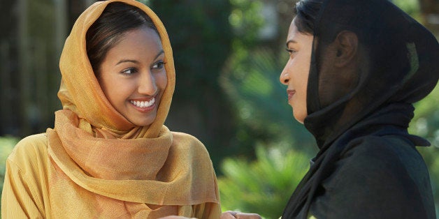 Two young muslim women talking outdoors