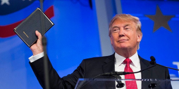 Donald Trump, president and chief executive of Trump Organization Inc. and 2016 Republican presidential candidate, holds up a Bible while speaking at the Values Voter Summit in Washington, D.C., U.S., on Friday, Sept. 25, 2015. The annual event, organized by the Family Research Council, gives presidential contenders a chance to address a conservative Christian audience in the crowded Republican primary contest. Photographer: Drew Angerer/Bloomberg via Getty Images 