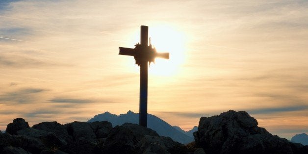 Iron cross at mountain top in alp. Cross on top of a mountains peak as typical in the Alps. Monument to the dead climbers