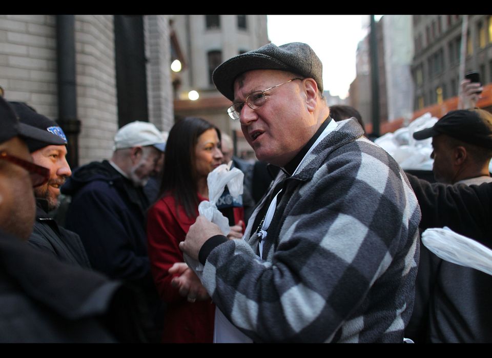 Cardinal Timothy Dolan Hands Out Meals To The Needy On Ash Wednesday