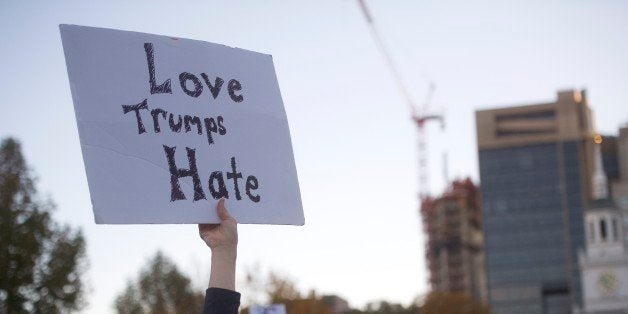 PHILADELPHIA, PA - NOVEMBER 13: A protestor demonstrates against President-elect Donald Trump outside Independence Hall with a sign stating 'Love Trumps Hate' on one side, and his child's drawing on the other side, November 13, 2016 in Philadelphia, Pennsylvania. The Republican candidate lost the popular vote by more than a million votes, but won the electoral college. (Photo by Mark Makela/Getty Images)