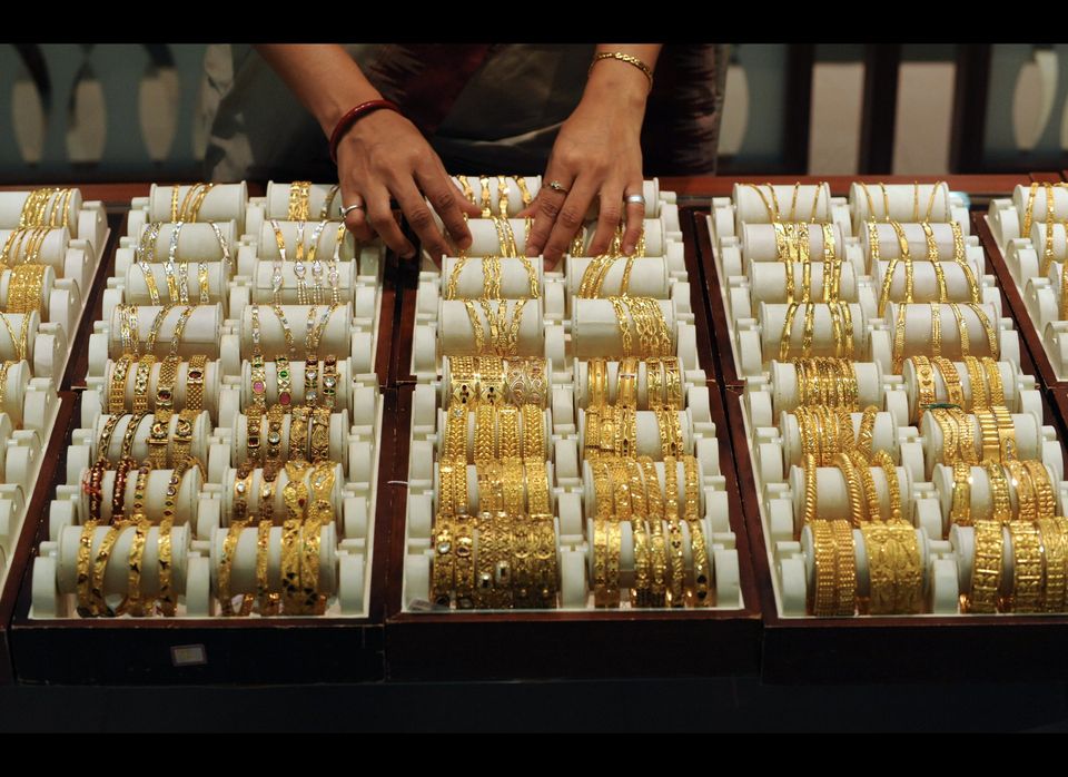 An Indian sales person arranges bangles