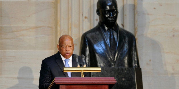 Rep. John Lewis, D-Ga., stands in front of a statue of Dr. Martin Luther King, Jr., as he speaks during a 50th anniversary ceremony for the Civil Rights Act of 1964, Tuesday, June 24, 2014, in the Capitol Rotunda on Capitol Hill in Washington. A Congressional Gold Medal in honor of Dr. and Mrs. Martin Luther King, Jr., who were instrumental in the lawâs passage, was also presented. (AP Photo/Susan Walsh)