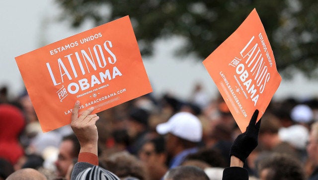 DENVER, CO - OCTOBER 04: Latino supporters hold up signs as they attend a campaign rally for U.S. President Barack Obama at Sloan's Lake Park on October 4, 2012 in Denver, Colorado. Obama spoke the morning after the first Presidential debate at the University of Denver. (Photo by Doug Pensinger/Getty Images)