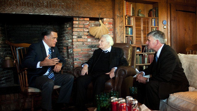 US Republican presidential candidate Mitt Romney (L) speaks with the Reverend Billy Graham (C) and his son Franklin (R) during a visit to the Graham's Cabin in Montreat, North Carolina, on October 11, 2012. AFP PHOTO/Jim WATSON (Photo credit should read JIM WATSON/AFP/GettyImages)