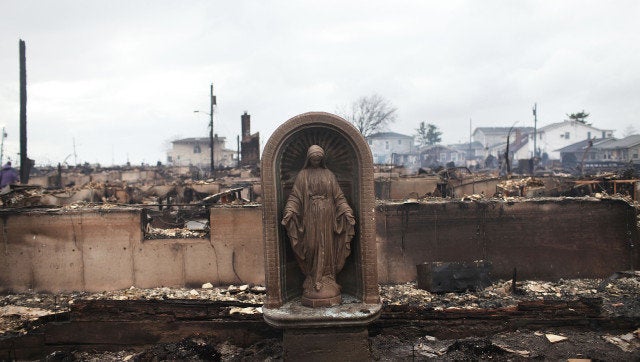 NEW YORK, NY - OCTOBER 30: A Virgin Mary is all that remains from a home which was destroyed during Hurricane Sandy in Breezy Point, Queens on October 30, 2012 in New York, United States. Over 50 homes wer destroyed in a late night and fast moving fire. At least 15 people were reported killed in the United States by Sandy as millions of people in the eastern United States have awoken to widespread power outages, flooded homes and downed trees. New York City was hit especially hard with wide spread power outages and significant flooding in parts of the city. (Photo by Spencer Platt/Getty Images)