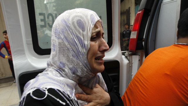 The mother of Palestinian boy Abdel Rahman Majdi Naim cries after her son was killed in a second Israeli strike on the building housing AFP's offices in Gaza city, according to Hamas health officials, on November 21, 2012. The Israeli military had no immediate comment on the strike, which came less than 24 hours after Israeli warplanes carried out a first raid on the building. AFP PHOTO/MOHAMMED ABED (Photo credit should read MOHAMMED ABED/AFP/Getty Images)