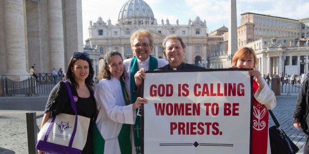 From right, Janice Sevre, Reverend Roy Bourgeois, Ree Hudson, Donna Rougeux and Erin Saizhanna, members of the Women's Ordination Conference group, stage a protest in front of St. Peter's basilica in Rome, Monday, Oct. 17, 2011. A U.S. Catholic priest who supports ordination for women has been detained by police after marching to the Vatican to press the Holy See to lift its ban on women priests. The Rev. Roy Bourgeois and two supporters were taken away Monday in a police car after their group marched down the main boulevard leading to the Vatican and chanted outside St. Peter's Square "What do we want? Women priests!". (AP Photo/Andrew Medichini)