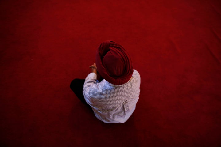 BROOKFIELD, WI - AUGUST 6: A member of the Sikh community attends a special service along with other mourners at the Sikh Religious Society of Wisconsin for the victims of the shooting at the Sikh Temple of Wisconsin the previous day, on August 6, 2012 in Brookfield, Wisconsin. Wade Michael Page opened fire with a 9mm pistol at the Sikh Temple killing six people before being killed by police in a shootout. (Photo by Darren Hauck/Getty Images)