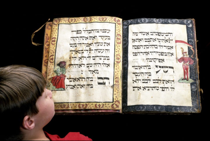 Child studies ancient handwritten Haggadah