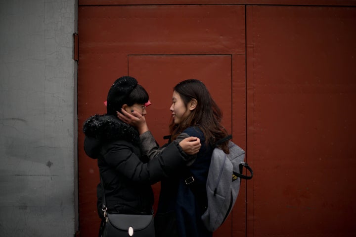 Elsie Liao (R) and Mayu Yu stand together in an alley outside the registry office where they asked to be married, before being turned away, in Beijing on February 25, 2013. Although not in a relationship together, the pair sought to draw attention to China's stance on same-sex marriage which is not recognised by law, the lack of access to social benefits available to couples, and to promote public awareness of discrimination against the LGBT community. China's government has an un-verified but widely reported 'three no's' policy towards homosexuality; no approval, no disapproval, no promotion. Same-sex acts were decriminalised in China in 1997, and homosexuality was removed from the country's mental illness list in 2001. As of June 2012 a 14-year-old ban was lifted allowing lesbians, although not gay men, to give blood. AFP PHOTO / Ed Jones (Photo credit should read Ed Jones/AFP/Getty Images)