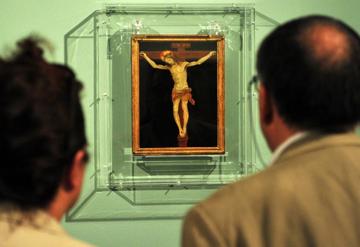 Visitors look at 'Crucifixion' by 15th century master Filippino Lippi during the 'Filippino Lippi and Sandro Boticelli nella