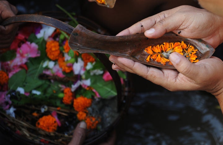 Indian Hindu devotees perform 'Tarpan', rituals to pay obesience to one's forefathers on the last day of 'Pitrupaksh' - days for offering prayers to ancestors, on the banks of the holy river Ganga in Kolkata on October 15, 2012. In Hindu mythology this day is also called 'Mahalaya' and describes the day when the gods created the ten armed goddess Durga to destroy the demon king Asura who plotted to drive out the gods from their kingdom. The five-day period of worship of Durga, who is attributed as the destroyer of evil, commences on October 20. AFP PHOTO/Dibyangshu SARKAR (Photo credit should read DIBYANGSHU SARKAR/AFP/GettyImages)