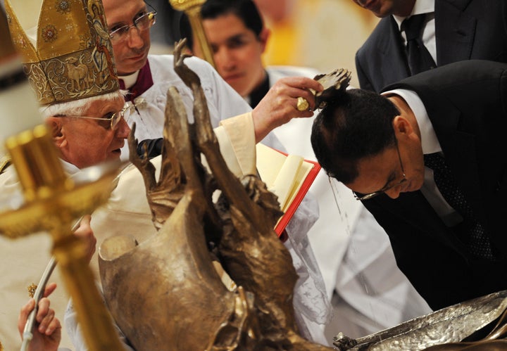 Italian editor and critic of Islamic extremism Magdi Allam, who converted to Catholicism from Islam, is baptised by Pope Benedict XVI during Easter Vigil mass in St Peter's Basilica at the Vatican, on March 22, 2008. The Pontiff presided a night mass at whitch Catholics are asked to renew their baptismal vows, before leading the church in the most joyful day of its calendar on Easter Sunday, when Christians celebrate the Resurrection of the Christ.AFP PHOTO / CHRISTOPHE SIMON (Photo credit should read CHRISTOPHE SIMON/AFP/Getty Images)