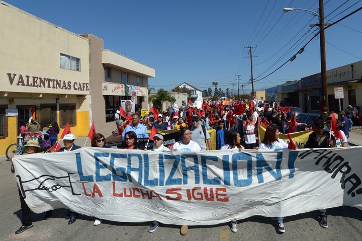 Hundreds of people march through the streets of Oxnard, California, as they participate in a march for immigration reform and to honor the legacy of Cesar E. Chavez, founder of the United Farm Workers of America, on March 24, 2013. AFP PHOTO/JOE KLAMAR (Photo credit should read JOE KLAMAR/AFP/Getty Images)