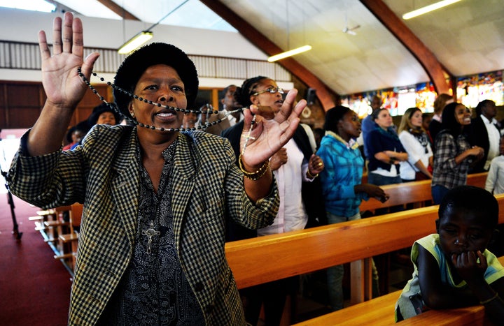 A church goer sings and dances at Regina Mundi church in Soweto on March 31, 2013. Regina Mundi church is situated near former South African president Nelson Mandela's old residence and is known for its involvement during the struggle against apartheid. Mandela is spending his fourth day in hospital after making 'steady progress' for a recurring lung infection. The 94 year old is idolised in his home nation. It is the second time within a month that he has been admitted to hospital, after spending a night for check-ups on March 9, 2013. AFP PHOTO/Carl de Souza (Photo credit should read CARL DE SOUZA/AFP/Getty Images)