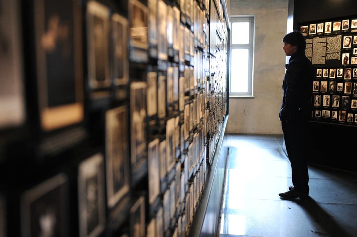 OSWIECIM, POLAND - JUNE 01: German coach Joachim Loew looks at personal photos that belonged to incoming prisoners in the so-called Central Sauna Building during a visit by a German Football Association (DFB) delegation to the Auschwitz-Birkenau memorial and former concentration camp ahead of Euro 2012 on June 1, 2012 in Oswiecim, Poland. (Photo by Markus Gilliar - Pool/Getty Images)