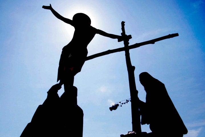 MESSOLOGI, GREECE: Greek Orthodox priests carry a replica of the body of Jesus Christ during a ceremony marking the removal of Christ from the cross near the town of Messologi, around 250 kilometers west of Athens, 29 April 2005. A similar ritual is held at churches across Greece during the Orthodox Easter. AFP PHOTO / Dimitris Dimitriou (Photo credit should read DIMITRIS DIMITRIOU/AFP/Getty Images)