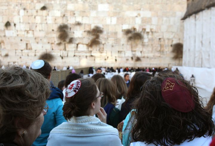 Women of the Wall, a group of religiously-observant Jewish women, wear kippas (Jewish skullcap) as they hold a prayer service at the Western Wall, Judaism holiest site, in Jerusalems old city on November 8, 2010 to mark one year since a woman was arrested for carrying a Torah and wearing a prayer shawl in what is considered an illegal act. AFP PHOTO/GALI TIBBON (Photo credit should read GALI TIBBON/AFP/Getty Images)