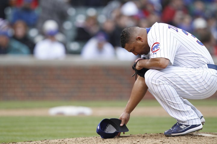 CHICAGO, IL - MAY 12: Carlos Zambrano #38 of the Chicago Cubs kneels to pray before pitching against the Florida Marlins at Wrigley Field on May 12, 2010 in Chicago, Illinois. The Cubs defeated the Marlins 4-3. (Photo by Joe Robbins/Getty Images)