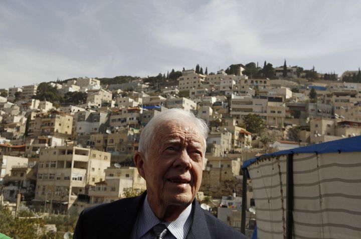 Former US president Jimmy Carter tours the flashpoint Arab east Jerusalem neighbourhood of Silwan where he and other members of The Elders group met with Palestinian residents on October 21, 2010. AFP PHOTO/POOL/AMMAR AWAD (Photo credit should read AMMAR AWAD/AFP/Getty Images)