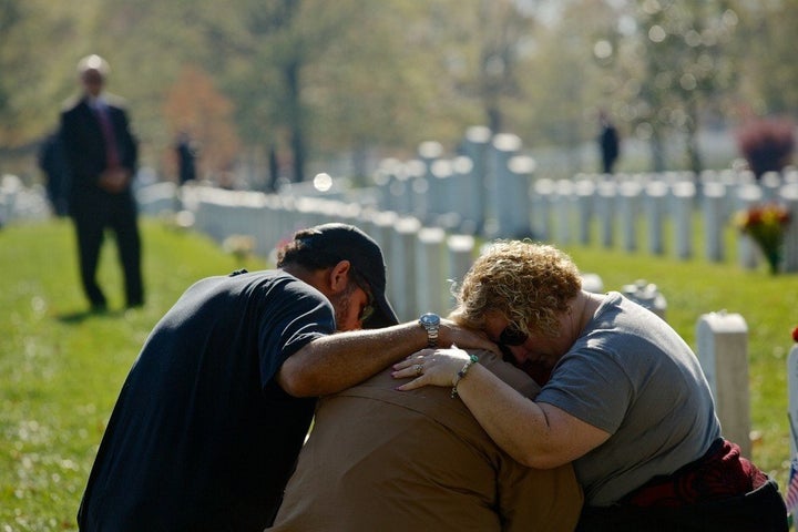 ARLINGTON, VA - NOVEMBER 11: Chuck Jackson (L) and Kimberly Shrauger (R) comfort Kimberly's husband Lowell Shrauger as he vi
