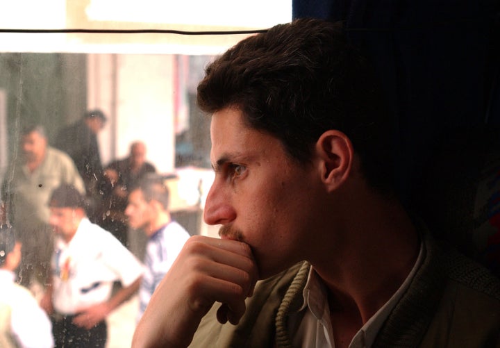 AMMAN, JORDAN - APRIL 4: An Iraqi man looks outside the window of a bus as he departs April 4, 2003 for the 600 km. ride to