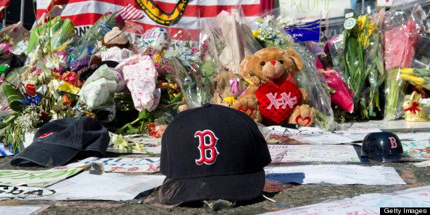 A Boston Red Sox cap left at a makeshift memorial on the Boston Marathon route April 18, 2013 in Boston. No arrests have been made in connection with the twin bombings that are the worst attack in the United States since the September 11, 2001 attacks. AFP PHOTO/Don Emmert (Photo credit should read DON EMMERT/AFP/Getty Images)