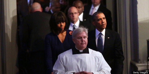 BOSTON, MA - APRIL 18: President Barack Obama (R) and first lady Michelle Obama enter an interfaith prayer service for victims of the Boston Marathon attack titled 'Healing Our City,' at the Cathedral of the Holy Cross on April 18, 2013 in Boston, Massachusetts. Authorities investigating the attack on the Boston Marathon have shifted their focus to locating the person who placed a black bag down and walked away just before the bombs went off. The twin bombings at the 116-year-old Boston race, which occurred near the marathon finish line, resulted in the deaths of three people and more than 170 others injured. (Photo by Spencer Platt/Getty Images)