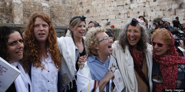 Members of the liberal religious group Women of the Wall wear phylacteries and 'Tallit' traditional Jewish prayer shawls for men as they sing and pray at the Western Wall in Jerusalem's Old City on April 11, 2013 marking the first day of the Jewish month of Iyar. Five members of the Women of the Wall organisation were detained by police in the midst of the liberal group's monthly prayer at the Western Wall, after covering themselves with a prayer shawl in contradiction to the holy site's custom. AFP PHOTO/GALI TIBBON (Photo credit should read GALI TIBBON/AFP/Getty Images)
