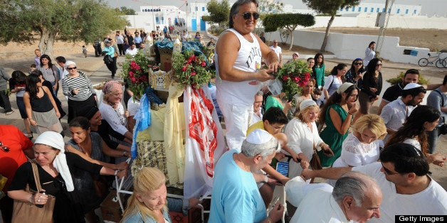 Jewish pilgrims, including members of Tunisia's diminished Jewish community, take part in the procession of the Menara outside the Ghriba synagogue on the Mediterranean resort island of Djerba on April 26, 2013. Pilgrims arrived at Tunisia's Ghriba synagogue, the oldest in Africa, expressing hope that this year would mark a turning point for the ritual despite a rise in Islamist unrest since the 2011 revolution. AFP PHOTO / FETHI BELAID (Photo credit should read FETHI BELAID/AFP/Getty Images)