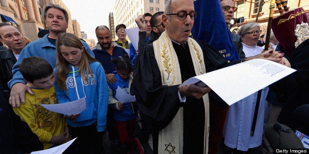 BOSTON, MA - APRIL 21: Rabbi Howard Berman of Central Reform Temple participates in an interfaith memorial service with members of six churches at a makeshift memorial for victims near the site of the Boston Marathon bombings at the intersection of Boylston Street and Berkley Street two days after the second suspect was captured on April 21, 2013 in Boston, Massachusetts. A manhunt for Dzhokhar A. Tsarnaev, 19, a suspect in the Boston Marathon bombing ended after he was apprehended on a boat parked on a residential property in Watertown, Massachusetts. His brother Tamerlan Tsarnaev, 26, the other suspect, was shot and killed after a car chase and shootout with police. The bombing, on April 15 at the finish line of the marathon, killed three people and wounded at least 170. (Photo by Kevork Djansezian/Getty Images)