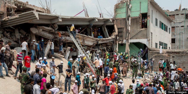 Rescue workers and volunteers search by hand for victims amongst the debris of the collapsed Rana Plaza building in Dhaka, Bangladesh, on Friday, April 26, 2013. The day after a Bangladesh building collapsed, killing more than 290 people, disagreement emerged over whether the owner obtained appropriate construction permits, adding to concerns over worker safety in the country's garment industry. Photographer: Jeff Holt/Bloomberg via Getty Images