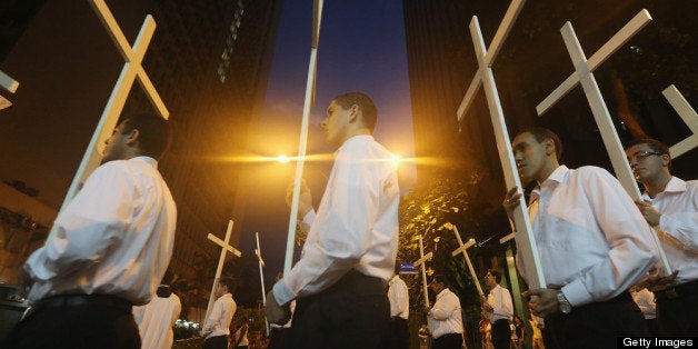 RIO DE JANEIRO, BRAZIL - MARCH 29: Catholics carry crosses in a Good Friday procession following Mass at the Metropolitan Ca