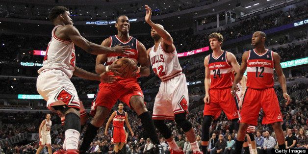 CHICAGO, IL - APRIL 17: Jason Collins #98 of the Washington Wizards tries to move between Jimmy Butler #21 (L) and Taj Gibson #22 of the Chicago Bulls at the United Center on April 17, 2013 in Chicago, Illinois. NOTE TO USER: User expressly acknowledges and agrees that, by downloading and or using this photograph, User is consenting to the terms and conditions of the Getty Images License Agreement. (Photo by Jonathan Daniel/Getty Images)