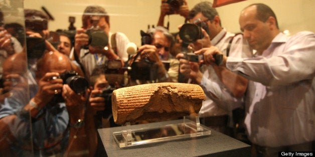 Photographers are seen at the unveiling on the Cyrus Cylinder, at the National Museum of Iran in Tehran on September 12, 2010. The artefact dating from the 6th century BC has been returned on loan to Iran by the British Museum in London under tight security measures. It will be displayed at the museum for four months. AFP PHOTO/ATTA KENARE (Photo credit should read ATTA KENARE/AFP/Getty Images)