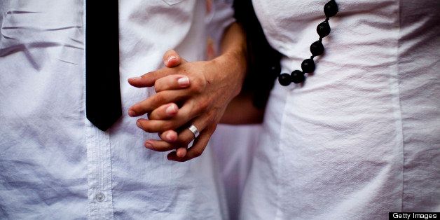 TEL AVIV, ISRAEL - JULY 25: (ISRAEL OUT) Bride Yulia Tagil and grome Stas Granin hold hands during their alternative wedding ceremony, on July 25, 2010 at a square in Tel Aviv, Israel. Tagil and her husband, Stas Granin, held the public wedding to protest the Jewish guidelines stating that the only way for Jews to marry by law is through the standards set by the Chief Rabbinate. (Photo by Uriel Sinai/Getty Images)