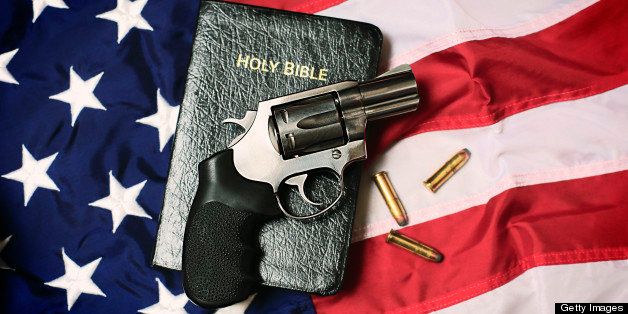 A handgun resting on a Bible and an American flag, representing the Second Amendment of the US Constitution, the right of patriotic Americans to bear arms, and the cross-section of religious American values. Social issues concept.