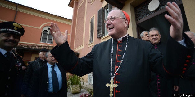 US cardinal and head of New York archdiocese, Timothy Michael Dolan (R), waves after leading a mass at the Nostra Signora di