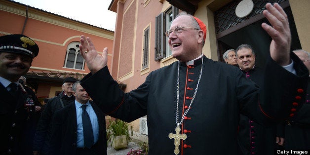 US cardinal and head of New York archdiocese, Timothy Michael Dolan (R), waves after leading a mass at the Nostra Signora di Guadalupe church (Our Lady of Guadalupe) on March 10, 2013 in Rome. Roman Catholic cardinals from around the world will assemble in the Vatican's Sistine Chapel from March 12 for a conclave to elect a new pope in an unprecedented transition after Benedict XVI's historic resignation. AFP PHOTO / FILIPPO MONTEFORTE (Photo credit should read FILIPPO MONTEFORTE,FILIPPO MONTEFORTE/AFP/Getty Images)