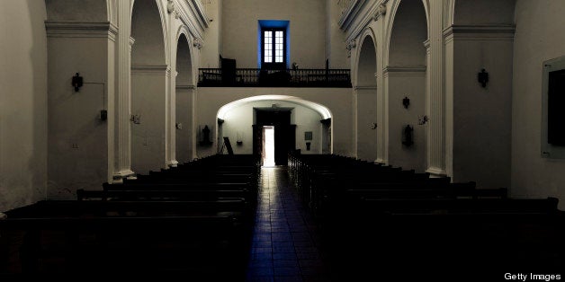 Light falling through open door and window in old ancient church in Uruguay, South America.