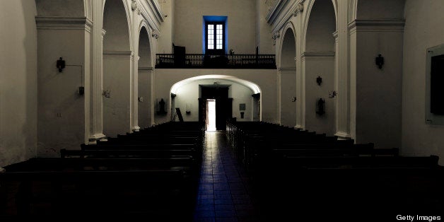 Light falling through open door and window in old ancient church in Uruguay, South America. 