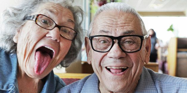 A senior couple having fun making silly faces. This time, it's Grandma photo bombing Grandpa's 'portrait'. :)