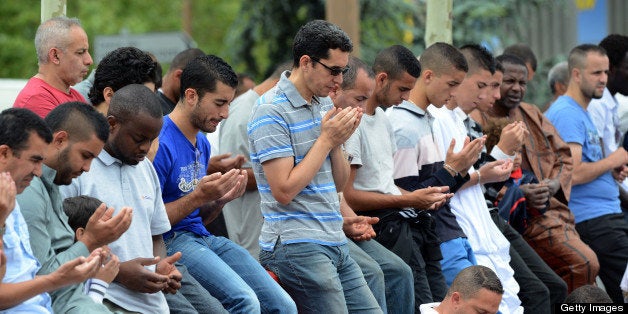 Muslims pray around the mosque of their Basso Combo neighbourhood, in Toulouse, southern France, on July 20, 2012, during the first day of Islam's holy month of Ramadan. Their mosque is a prefabricated building made available by Toulouse's municipalty for the faithful until the construction sceduled of a mosque in Basso Combo. AFP PHOTO / REMY GABALDA (Photo credit should read REMY GABALDA/AFP/GettyImages)