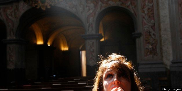 Austria, Lower Austria, Herzogenburg. The baroque church of the abbey of Herzogenburg. Woman praying. Austria.