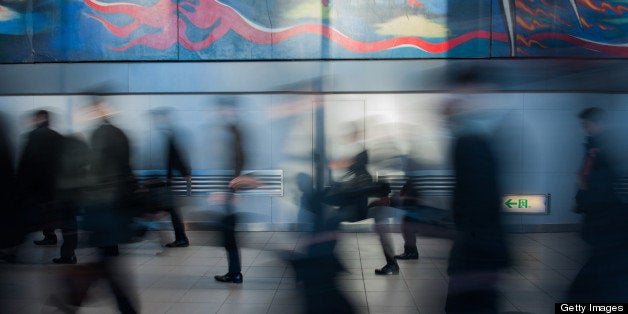 Morning commuters walk through Shibuya Station in Tokyo, Japan, on Monday, Dec. 10, 2012. Japan's economy shrank in the last