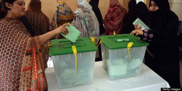 Pakistani residents cast their votes at a polling station in Islamabad on May 11, 2013. Pakistanis queued up to vote in landmark elections, defying Taliban attacks to cast their ballots in polls marking a historic democratic transition for the nuclear-armed state. AFP PHOTO / AAMIR QURESHI (Photo credit should read AAMIR QURESHI/AFP/Getty Images)