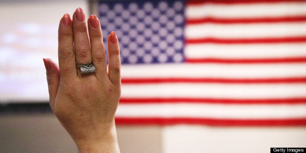 NEW YORK, NY - MAY 17: An immigrant takes the oath of citizenship to the United States at a naturalization ceremony held at