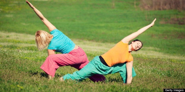 Young women practicing yoga in nature. Sun warrior.