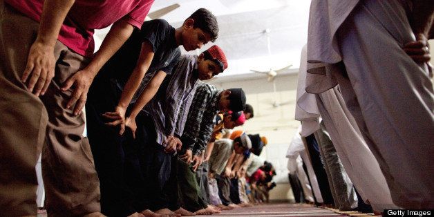 CHENAB NAGAR, PAKISTAN - JULY 14: Members of the persecuted Ahmadiyya community pray in a mosque on July 14, 2010 in Chenab Nagar, Pakistan. The Pakistani Ahmadis, define themselves as Muslim, but could face years in prison if they openly declare or practice their faith, have suffered persecution and discrimination in this Islamic country for decades. In May 2010, 93 people were killed and over 100 injured in attacks on two Ahmadiyya mosques in Lahore. The community fears further attacks in the small city of Chenab Nagar, which Ahmadis still call by its former name of Rabwah, where they have their Pakistani headquarters. (Photo by Daniel Berehulak/Getty Images)